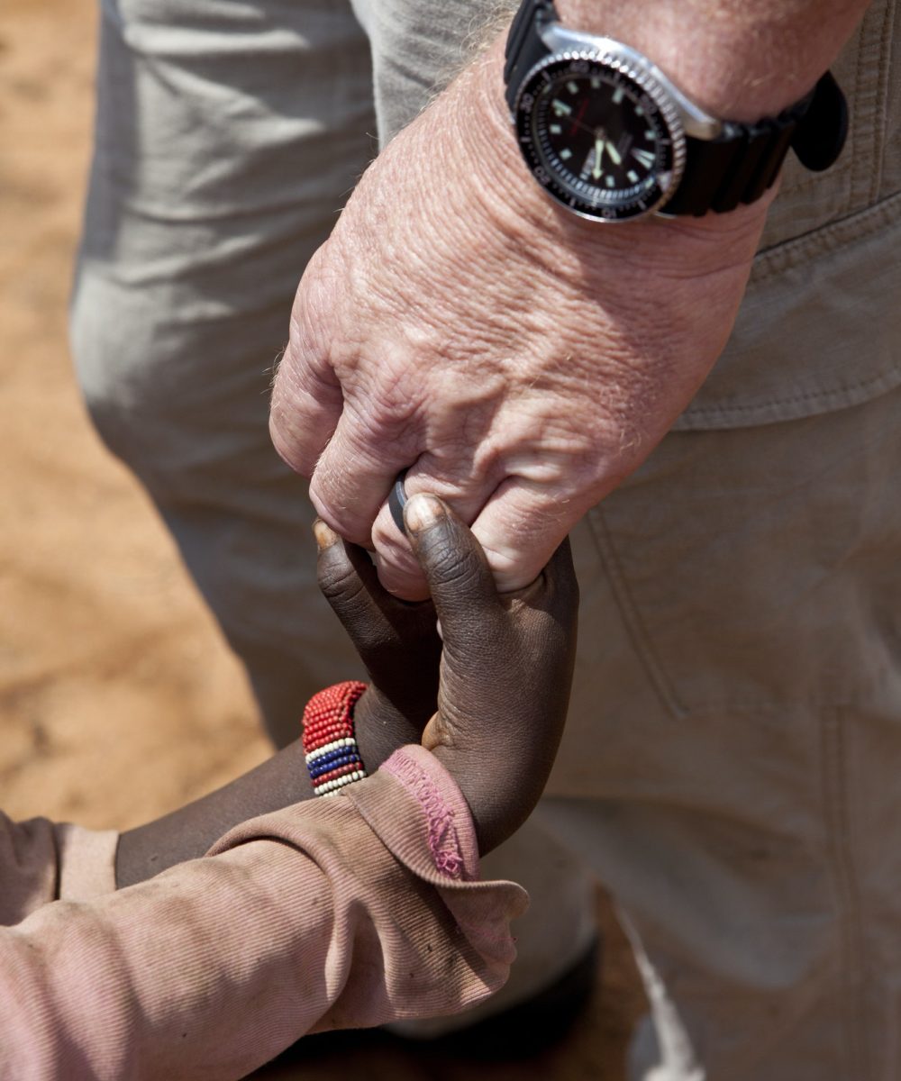 aid-worker-s-hands-holding-children-s-hands.jpg
